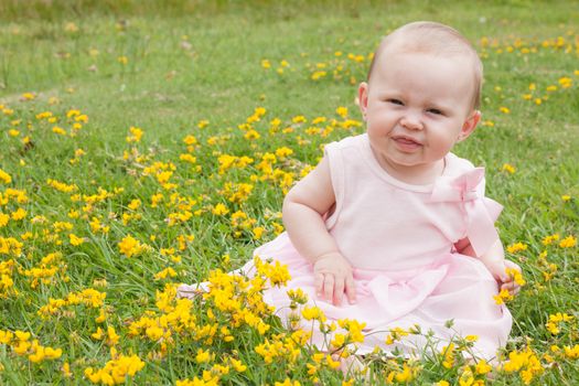 Sweet baby girl in a field of buttercups