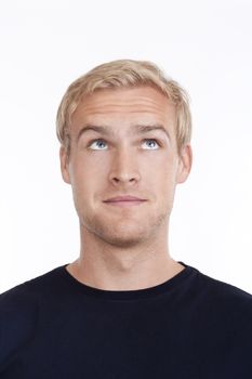 portrait of a young man with blond hair looking up - isolated on white