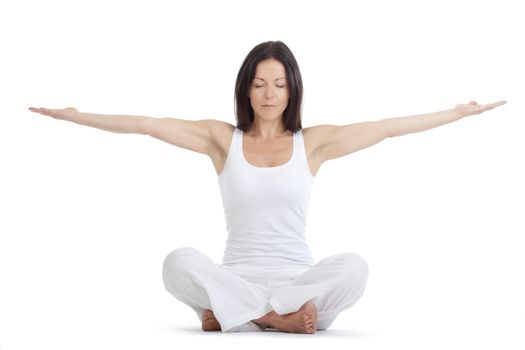 woman sitting on the floor exercising yoga - isolated on white