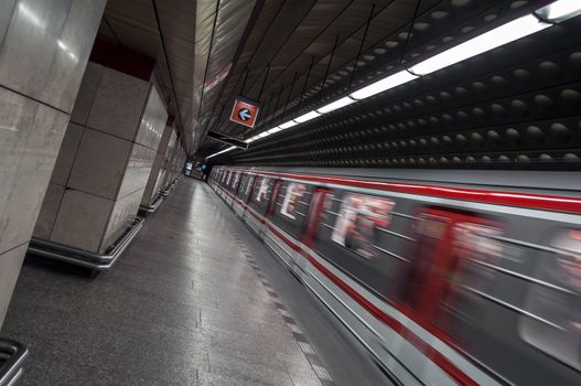 Train departing metro station with motion blur.