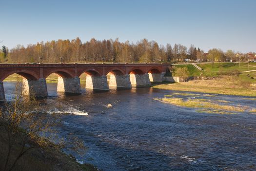 An old brick bridge on the banks of river Venta, Kuldiga, Latvia
