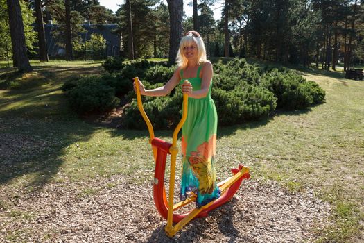 A woman working out on outdoor training equipment