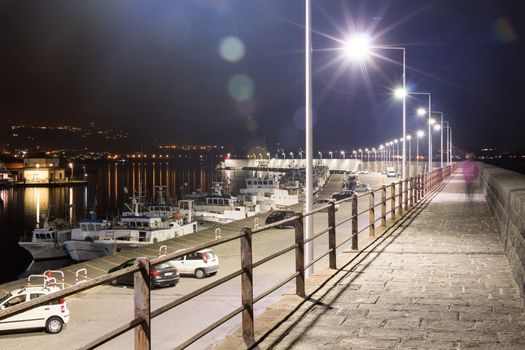 Pier by night with Taormina on the background