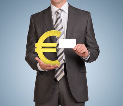 Businessman in suit hold empty card and gold euro sign. Blue background