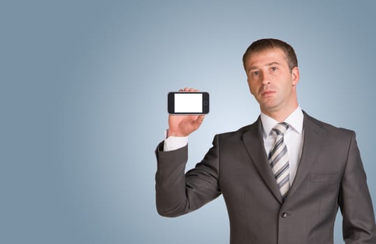 Businessman in suit hold smart phone with empty screen. Blue background