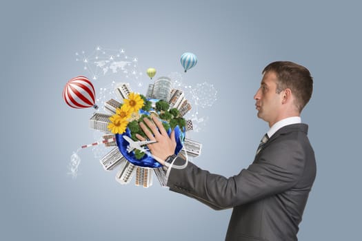 Businessman in suit hold Earth with buildings. Elements of this image are furnished by NASA