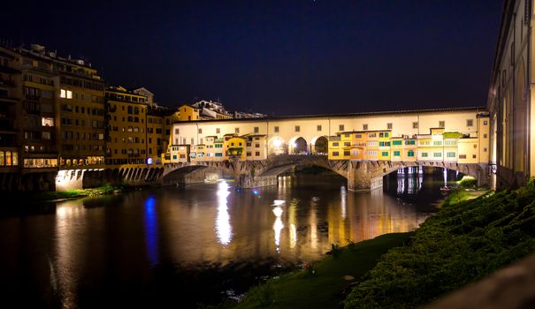 Pisa, Italy - August 11, 2013: Famous Ponte Vecchio night view over Arno river in Florence, Italy