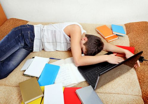 Teenager sleeps with the Books on the Sofa at the Home