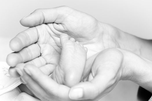 Closeup at a tiny foot of a newborn