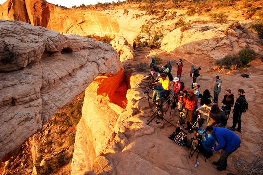 Photographers and tourists watching sunrise at  Mesa Arch, Canyonlands National Park, Utah