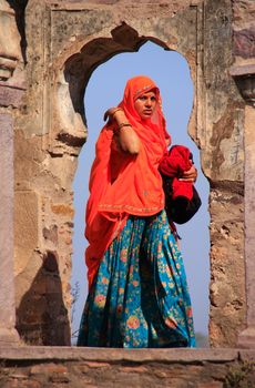 Indian woman in colorful sari standing in the arch, Ranthambore Fort, Rajasthan, India