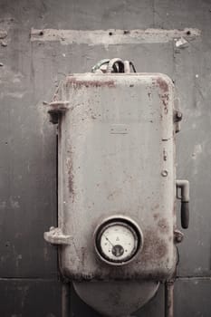 The old machinery instrument beside the wall