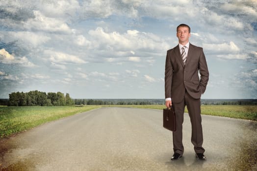 Businessman in suit with briefcase standing on the road. Business concept