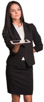 Beautiful businesswoman in suit holds tablet and looking at camera. Isolated on white background