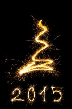 Merry christmas and happy new year 2015. Sparkling firework christmas and new year text on black background. Minimal abstract artistic style.