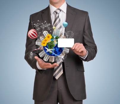 Businessman in suit hold empty card and Earth with buildings. Elements of this image are furnished by NASA
