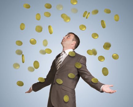 Businessman in suit spread his arms and looking up. Money fall from above