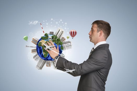 Businessman in suit hold Earth with buildings. Elements of this image are furnished by NASA