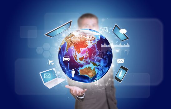 Businessman in suit hold Earth with electronics, graphs and icons. Elements of this image are furnished by NASA