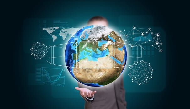 Businessman in suit hold Earth with graphs and network. Elements of this image are furnished by NASA