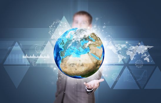 Businessman in suit hold Earth with graphs and network. Elements of this image are furnished by NASA