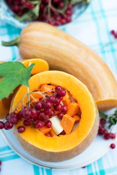 Pumpkin stuffed with a raw vegetables and viburnum