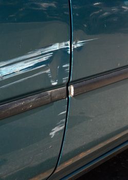 Close up on scratched door paint on a car