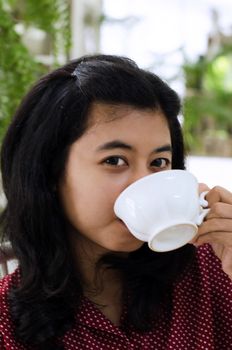 Young woman drinking a cup of tea