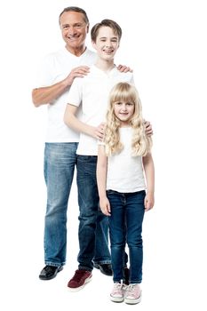 Smiling father, son and daughter posing to camera