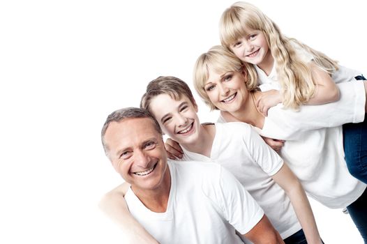 Happy family with two children posing together to camera