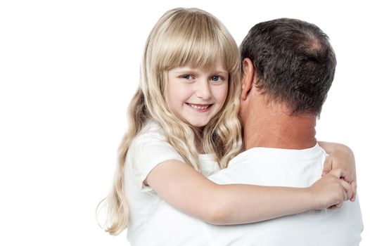 Smiling girl resting on her father's shoulder