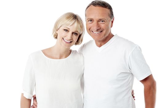 Smiling senior couple posing over white background