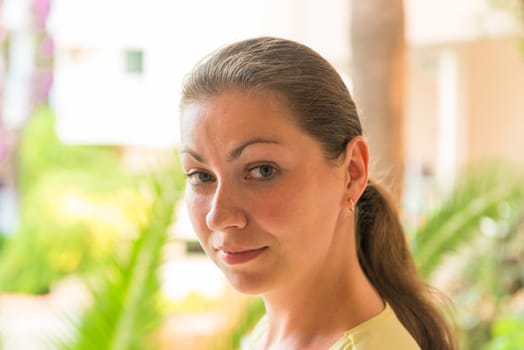 portrait of a girl on a background of palm leaf