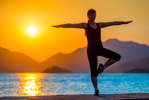 morning yoga at the sea on a background of mountains