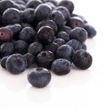 Picture of lots of blueberries over a white background