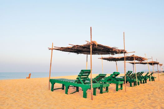 Beach umbrellas and deckchair on the tropical coast