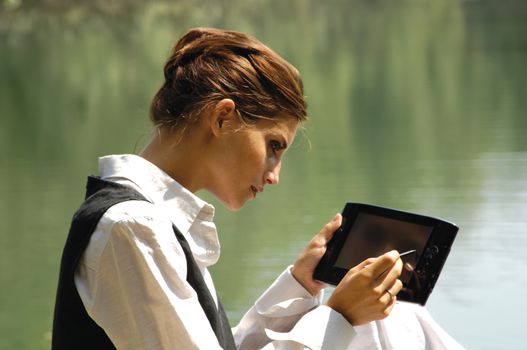 beautiful slender girl with a laptop on the nature 