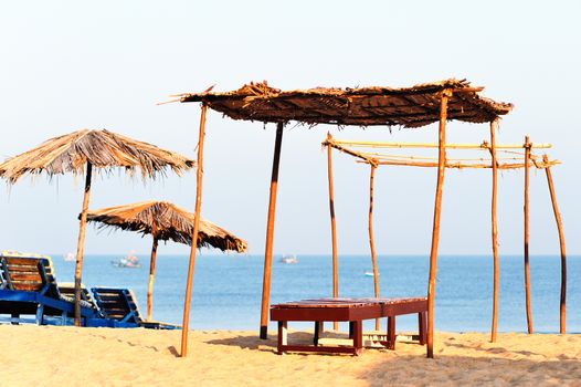 Beach umbrellas and deckchair on the tropical coast