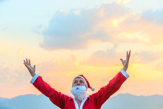 Santa Claus raised his hands to the sky