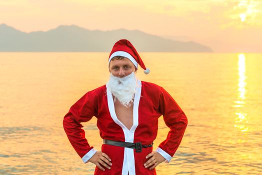 a young man in a Santa Claus costume posing