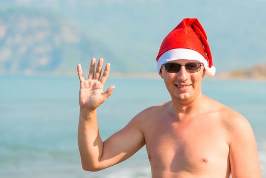 Portrait of a man in a Christmas hat on sea