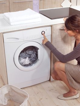 pretty smiling woman in the laundry room 