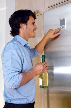 Man with his wineglass in his kitchen at home 