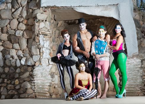 Smiling cirque troupe posing in outdoor stage