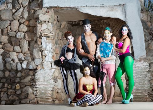 Smiling cirque troupe posing in outdoor stage