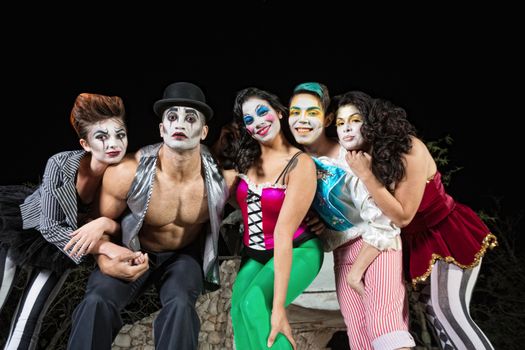 Group of character clowns posing on stage