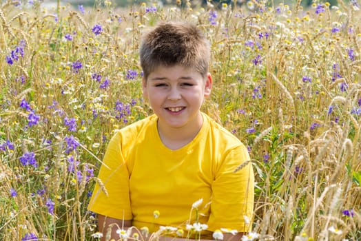 Boy in a field with a flowers