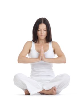 woman sitting on the floor exercising yoga - isolated on white