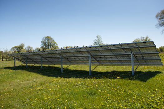 The back of a solar panel set on a meadow