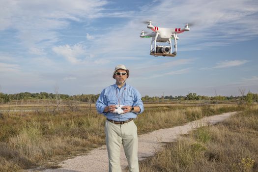 FORT COLLINS, CO, SEPTEMBER 28, 2014:  Photogrpaher, Marek Uliasz, is launching the DJI Phantom 2 quadcopter drone with Panasonic Lumix GM1 camera on board.